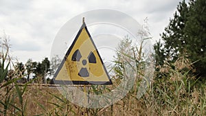 Radiation sign near forbidden Red Forest. A Sign of radioactive danger near nuclear power plant Chernobyl exclusion zone