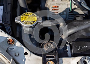 Radiator cap with warning label of a car