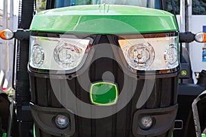 Radiator grille of the tractor with headlights.