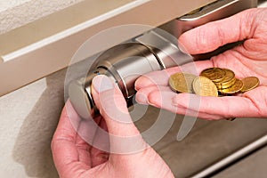 Radiator thermostat, coins and hand