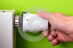 Radiator thermostat and hand - GREEN POWER energy SAVING concept