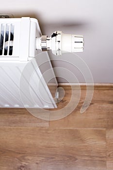 Radiator with thermostat in home interior