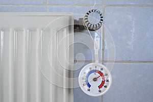 Radiator,valve and thermometer showing low temperature, shortage of heating gas due to the embargo of russian oil and gas in