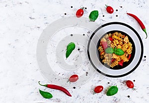 Radiatori pasta with chicken and peppers on white background. Top view