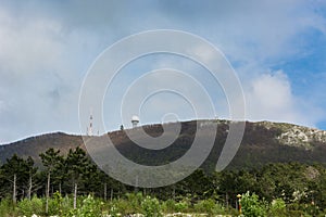 Radio antenna and radar on top of a mountain photo