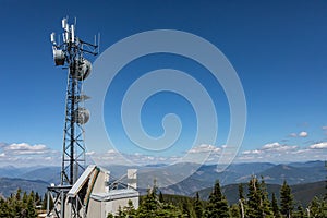 A radio antenna on the top of the mountain photo