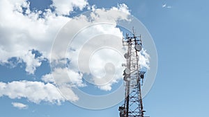 Radio, communication and cell towers on blue sky with clouds background. Satellite dish telecom network at sunset communication