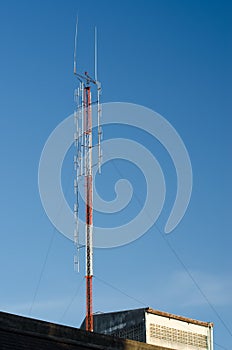 A radio communications tower against blue sky