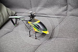 Radio-controlled helicopter on a textile background, a children`s toy