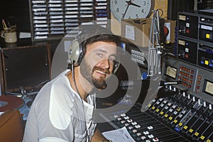 Radio disc jockey for station KFI in his studio, Los Angeles, CA