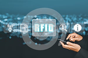 Radio frequency identification concept, Person using laptop computer and hand touching RFID icon on virtual screen