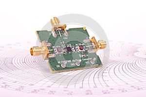 Radio frequency mixer PCB in front of Smith chart