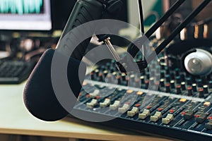 Radio host microphone, mixing console and headphones close-up