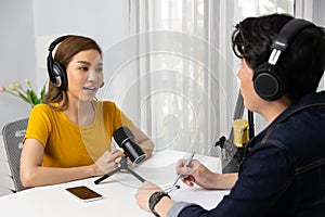 Radio influencer host wearing headphone interview woman social online. Infobahn.