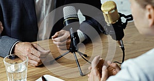 Radio interview, podcast recording - business people talking in broadcasting studio