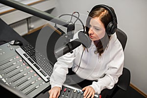 Radio Jockey Using Music Mixer While Communicating On Microphone