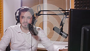 Radio and live broadcast concept. Young man with headphones talking on mic, online radio.