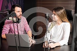 Radio presenter interviewing a guest for podcast photo