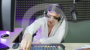 radio presenter in sleep mask and cosmetic patches on broadcast