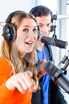 Radio presenters in radio station on air
