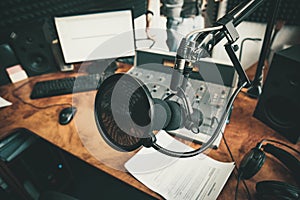 Radio station microphone in recording studio or broadcast room, working place of radio host, close up