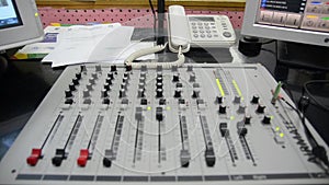 Radio station. Professional multitrack mixing console, computer and microphone in the control room. Recording and broadcasting pro