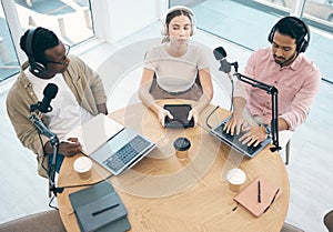 Radio, technology or broadcast with a content creator team in the office from above for streaming or recording. Podcast