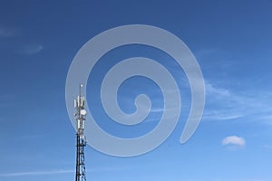 Radio tower with antennas on a blue sky background. Metal construction. Wireless tezhnologii. Transmission of a tele-radio signal.