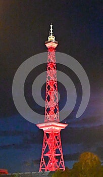 Radio tower illuminated in red at night in Berlin