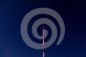 Radio tower on night starry sky background