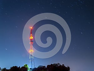 Radio tower on night starry sky background