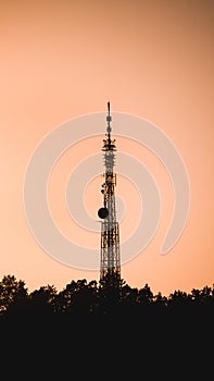 Radio tower on the top of the hill at sunset