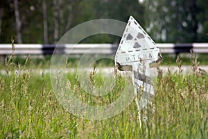 Radioactive danger sign among green grass