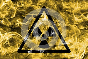 Radioactive substances or ionising radiation hazard warning smoke sign. Triangular warning hazard sign, smoke background. photo