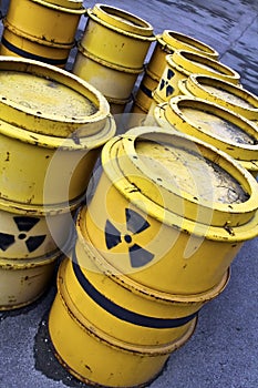 Radioactive warning symbol on yellow tuns of toxic