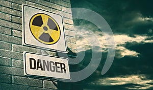 Radioactivity and chemical hazard street sign with toxic clouds photo