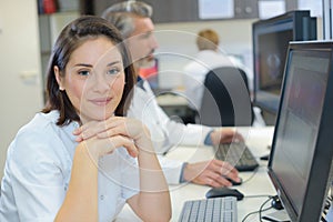 Radiographer posing in front computer photo
