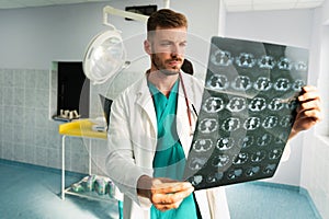 Radiologist, doctor examining x-ray images of patient for diagnosis