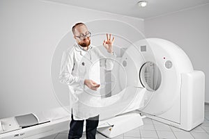 Radiologist with medical computed tomography or MRI scanner.