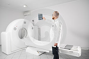 Radiologist with medical computed tomography or MRI scanner.