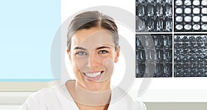 Radiologist woman smiling with xray in background