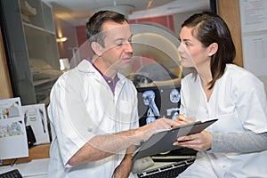 Radiologists looking at clipboard