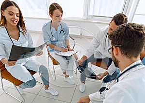 radiologists and a surgeon discussing a radiograph of a patient