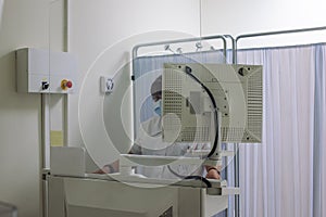 Radiology technician on x-ray machine monitor