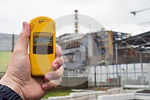 Radiometer in hand with fourth reactor on the background