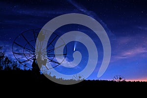 radiotelescopes silhouettes under night starry cloudy sky