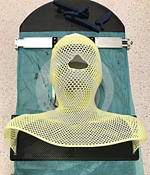 Radiotherapy immoblilising face and head mask for a male patient. Cancer treatment abstract