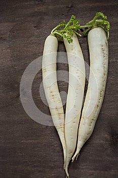 Radish daikon on a wooden background. Place for text