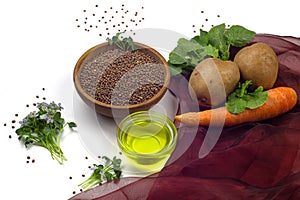 Radish oil, radish seeds in ceramic bowl, radish microgreen, potato and carrot