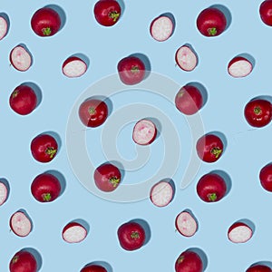 Radish and shadow in hard light on blue background as vegetable seamless pattern.
